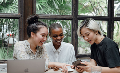 Team working together on laptops and phone